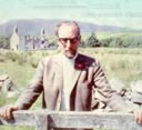 Gavin Maxwell standing in front of the fire ravaged cottage at Camusfearna